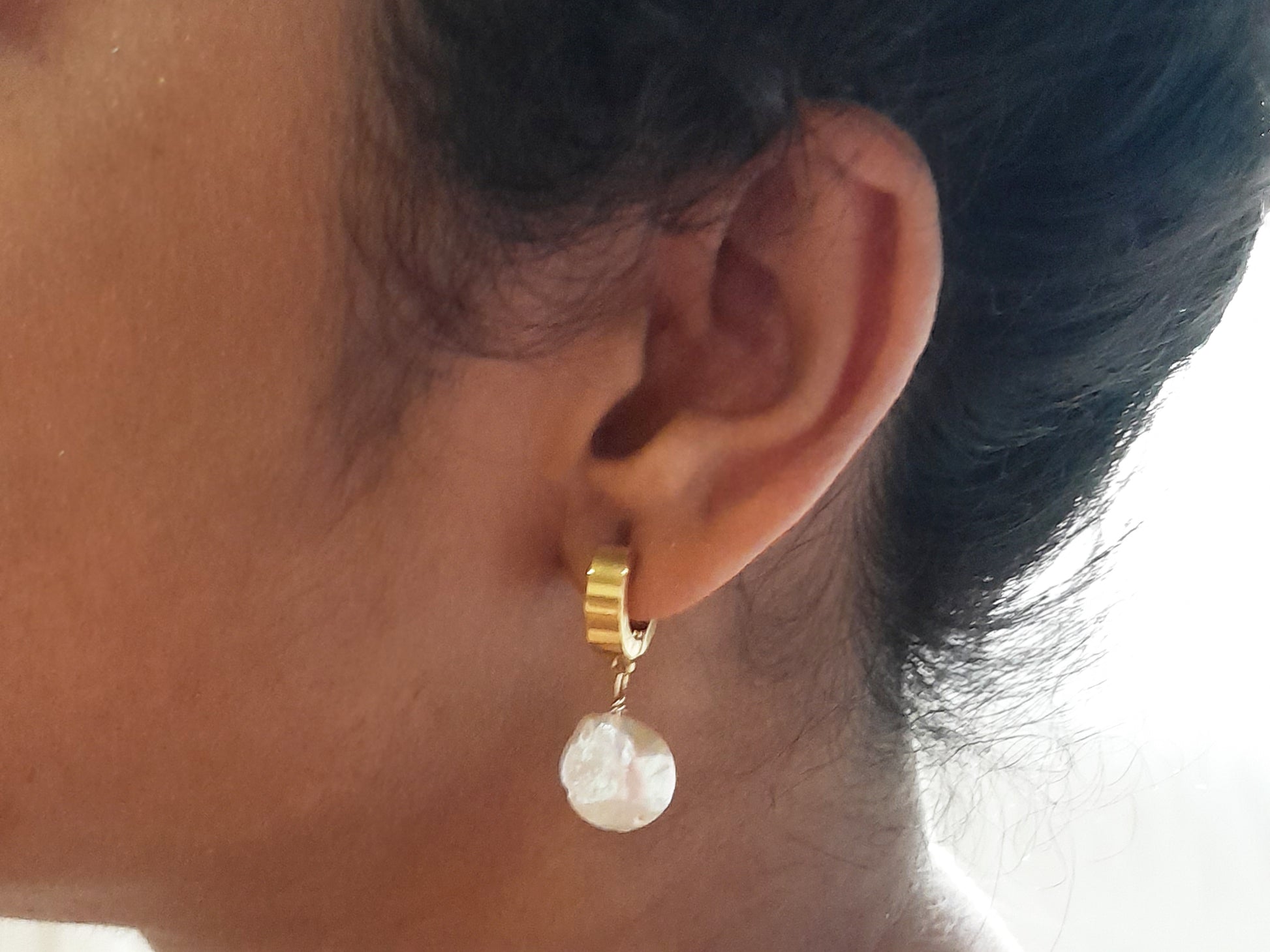 Thick gold hoop earrings with pearl charm