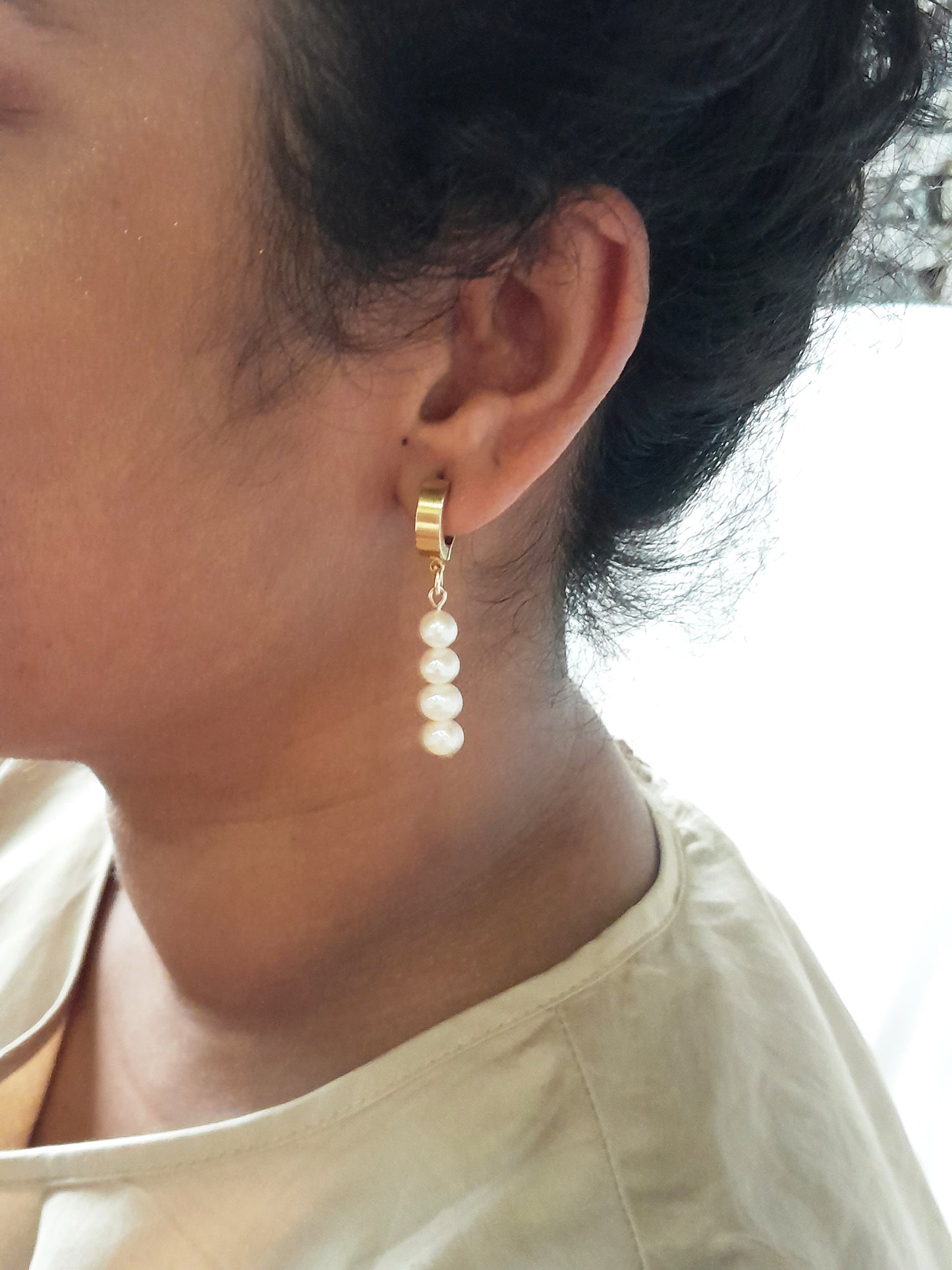 Thick gold hoop earrings with pearl charm