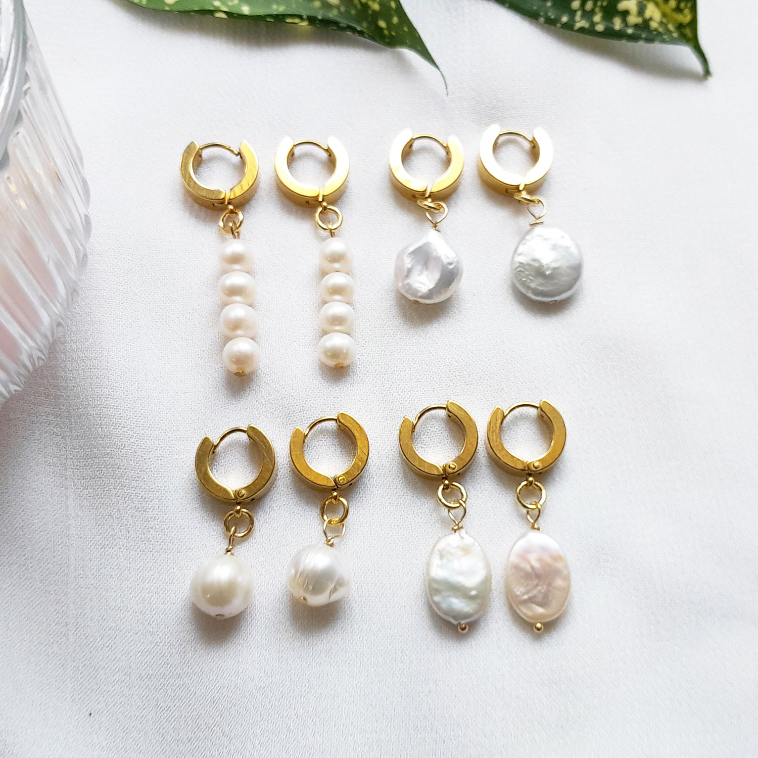 Thick gold hoop earrings with pearl charm