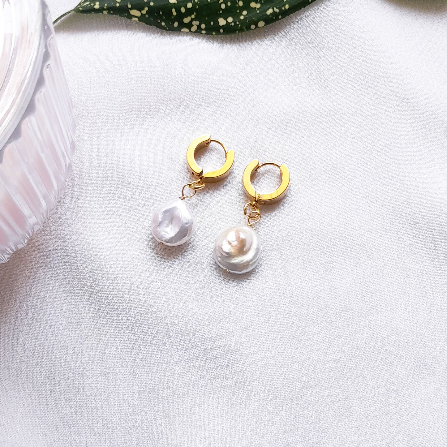 Thick gold hoop earrings with pearl charm