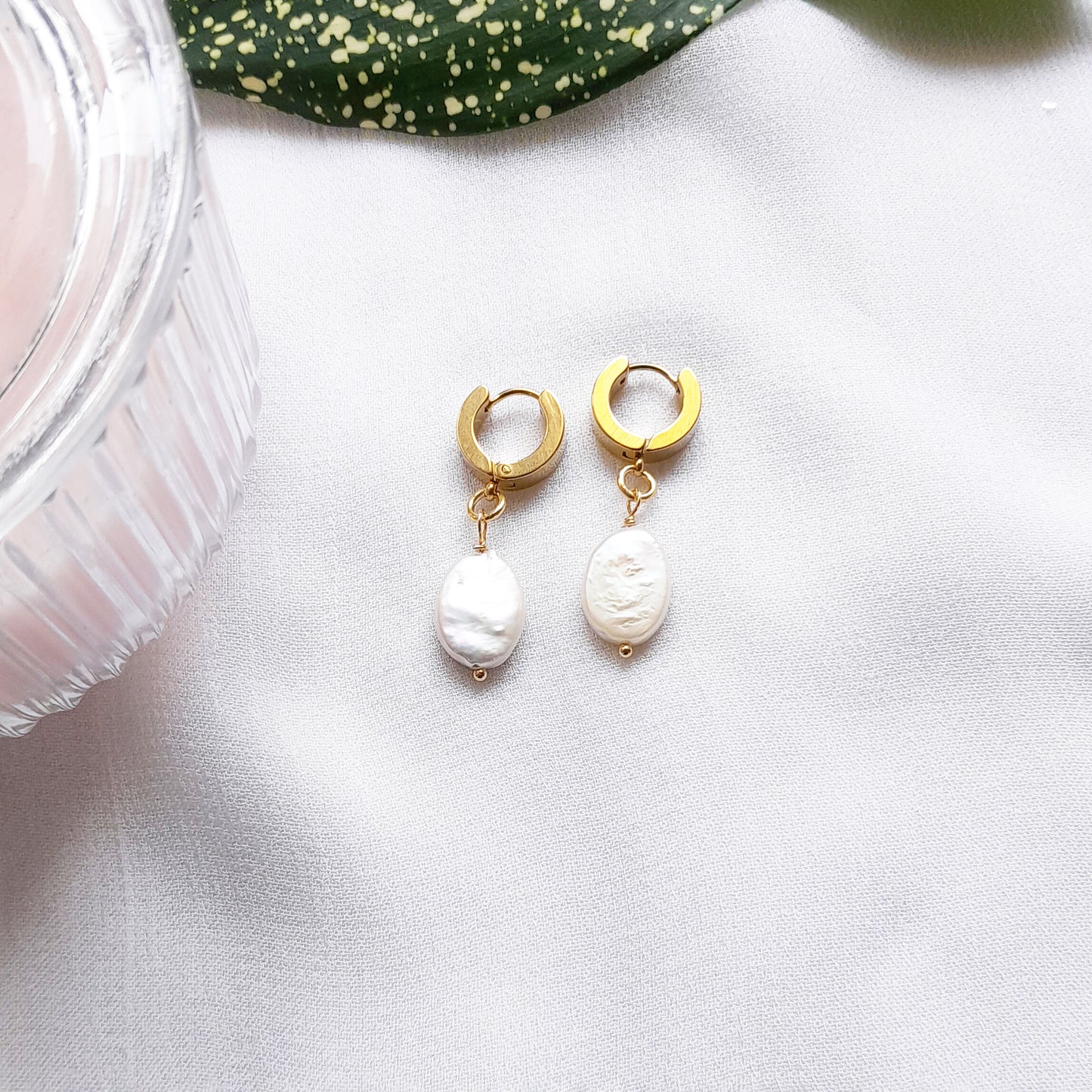 Thick gold hoop earrings with pearl charm