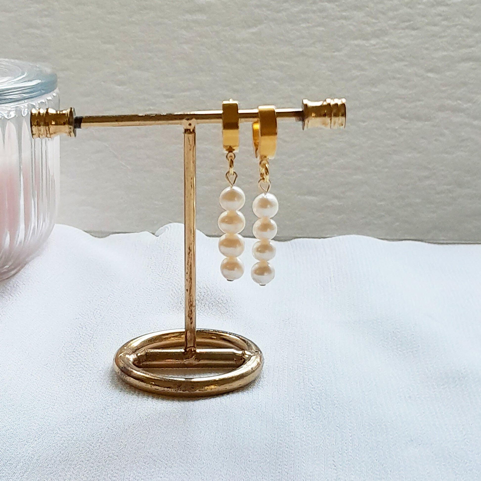 Thick gold hoop earrings with pearl charm